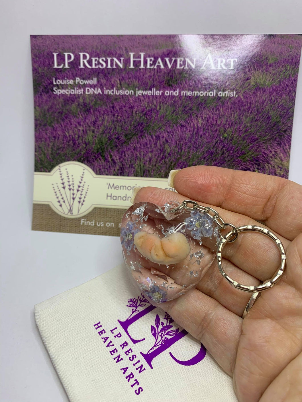 8-9 weeks womb baby keyring with forget me not flowers